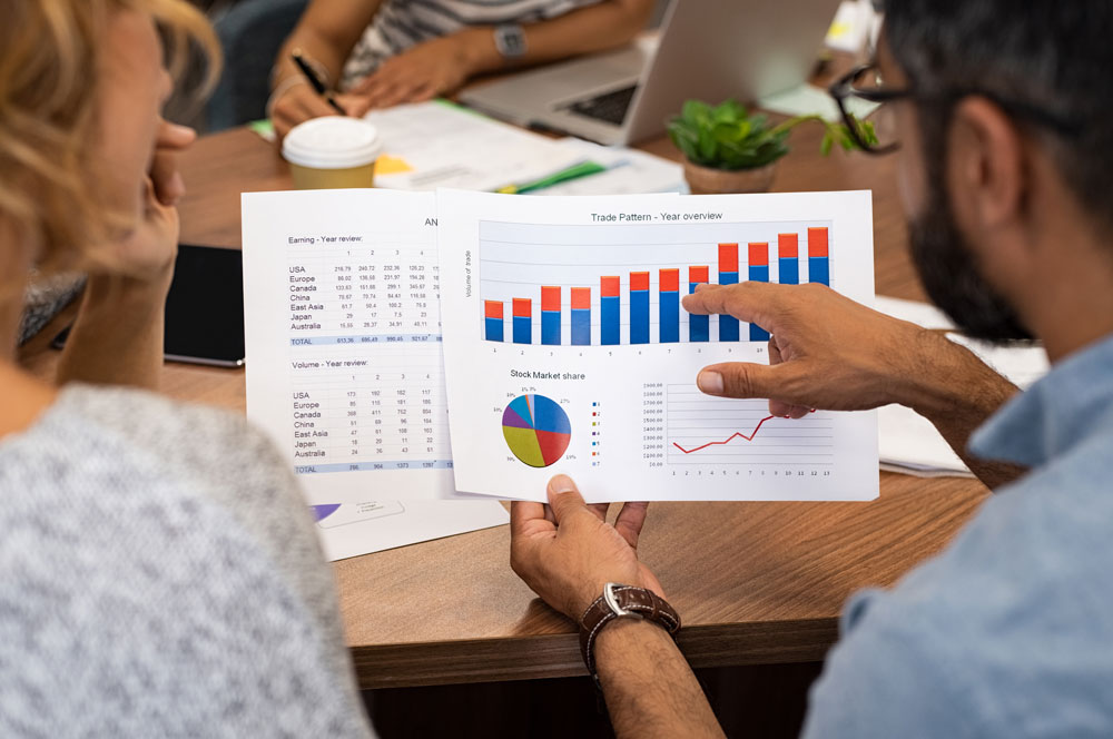 business-people-analyzing-graphs-YBKDRCN